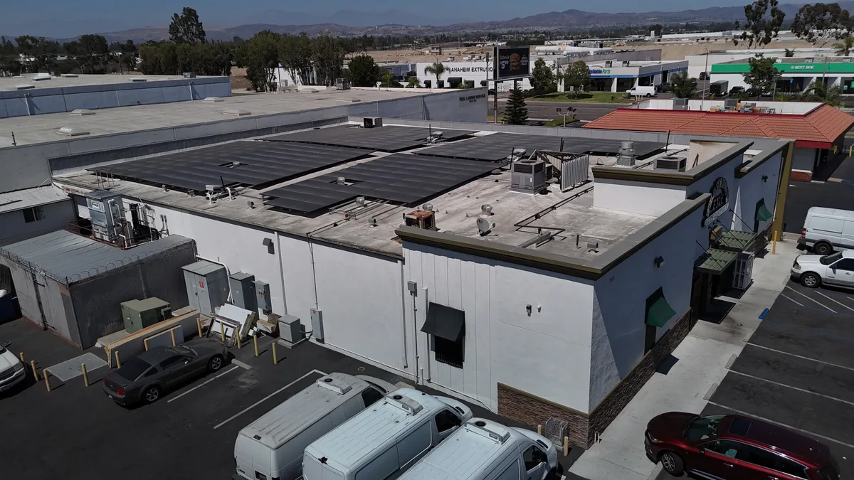 Aerial drone view of Francisco's Meat Company with its rooftop solar array and parking lot