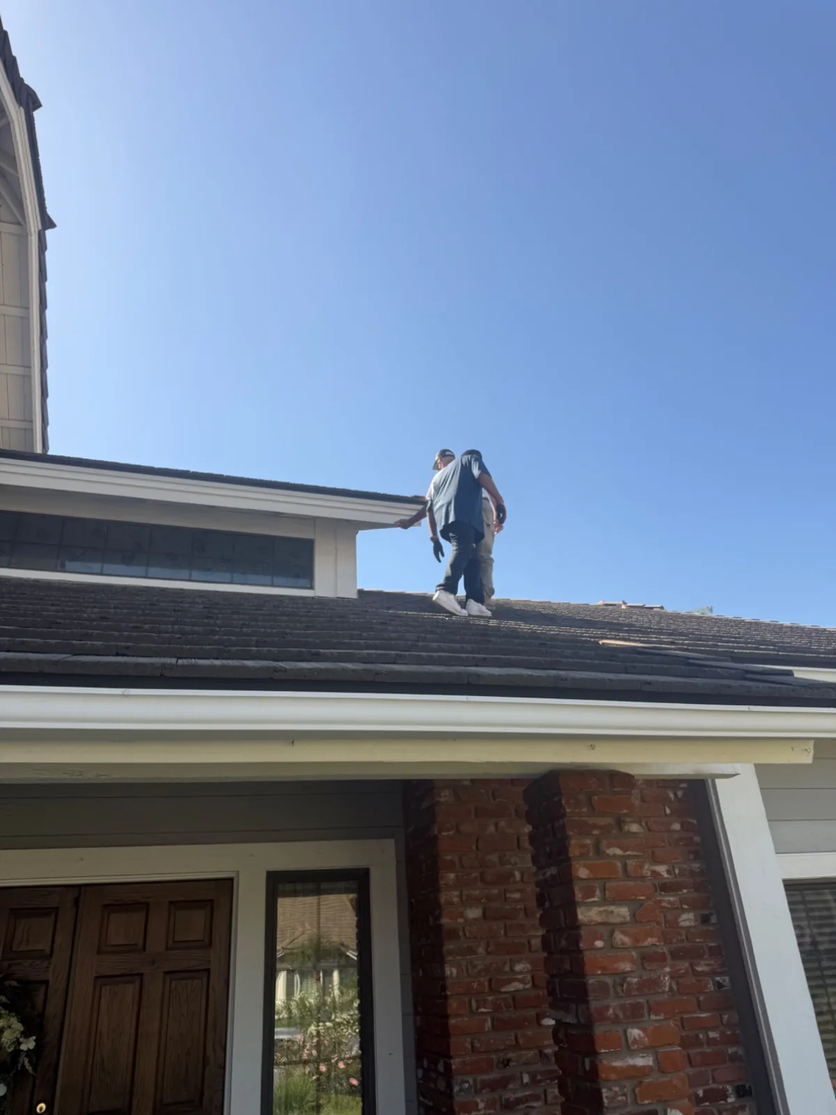 SolarCCS crew walking across a residential tile roof during a panel installation