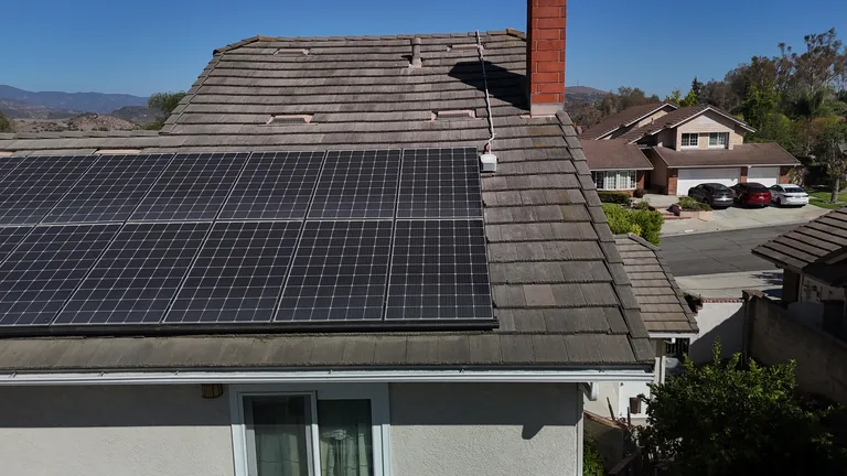 Aerial view of residential solar panel installation showing panel spacing and conduit run